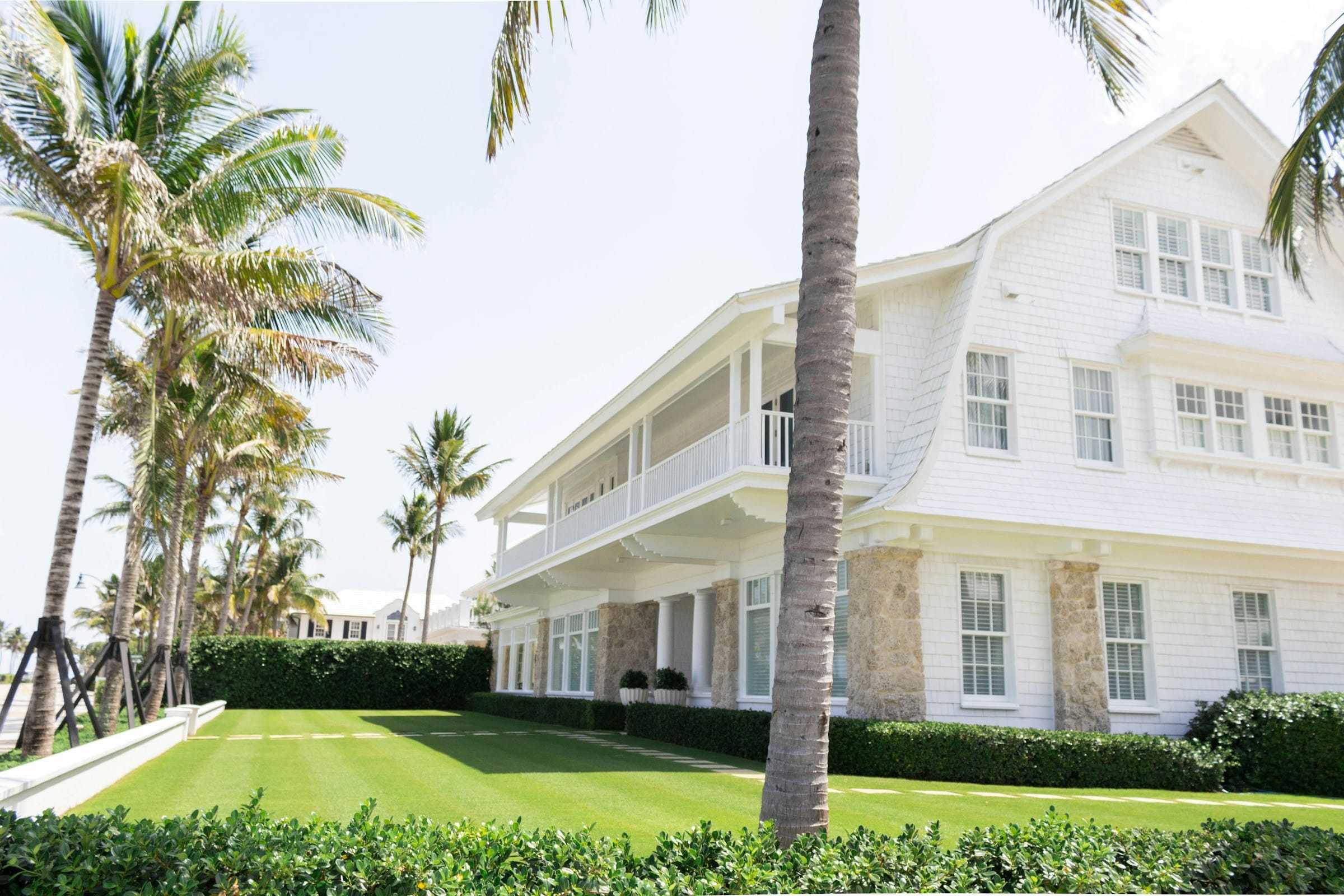 White Florida home with palm trees in the yard